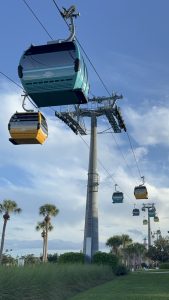 Disney Skyliner gondolas traveling near Disney's Riviera Resort