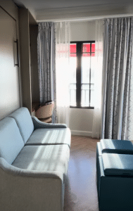 Sitting area in a Tower Studio at Disney's Riviera Resort with the Murphy bed folded into the wall